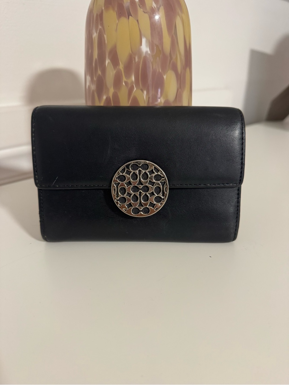 Classic Black Leather Wallet with Decorative Medallion